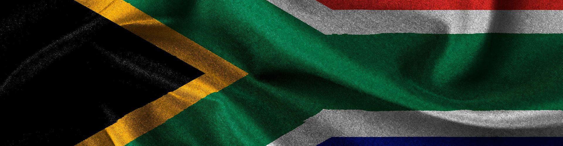 Close-up of the South African flag with vibrant colours and fabric texture in motion