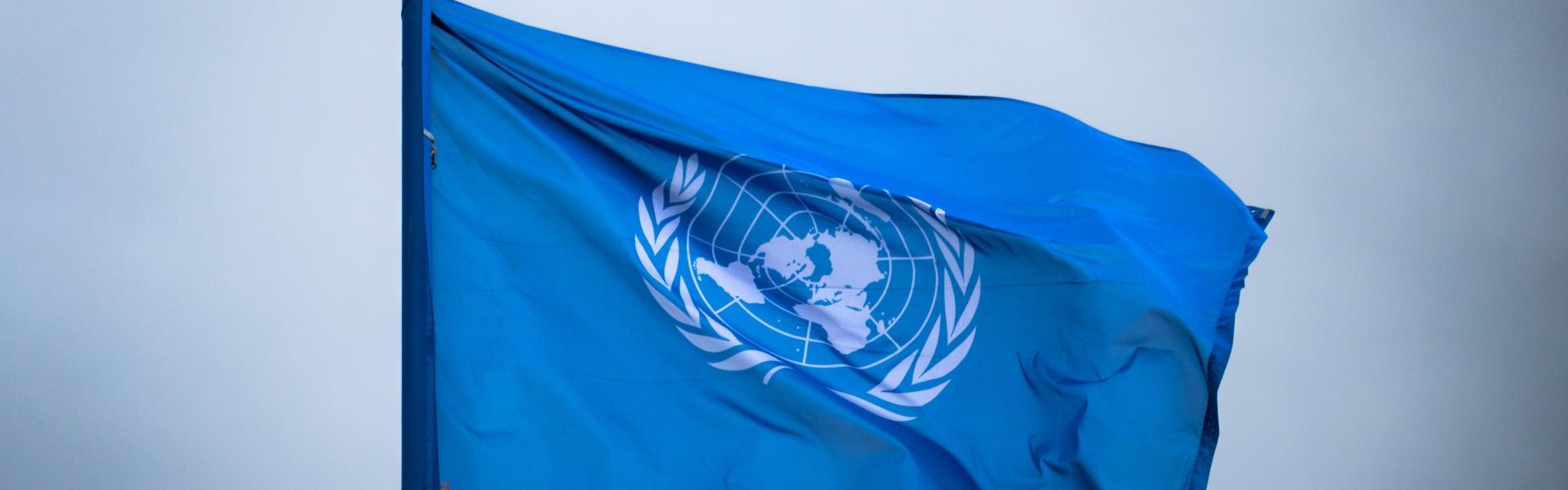 United Nations flag with a sky as backdrop
